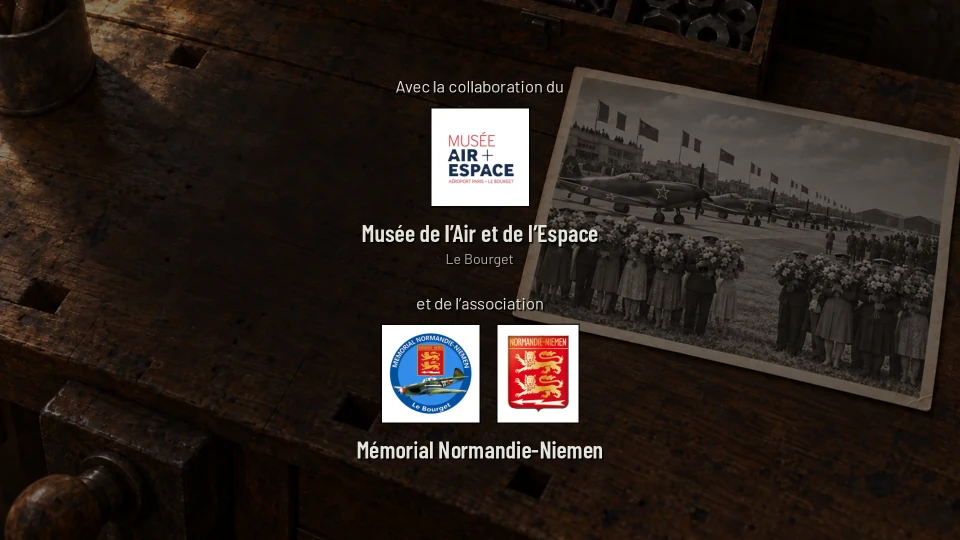 A credits screen over a darkened workbench and a photograph of fighters lined up on an airfield before a crowd holding flowers: the words Avec la collaboration du Musée de l’Air et de l’Espace, Le Bourget, with the museum’s logo, then et de l’association Mémorial Normandie-Niemen, with its two emblems